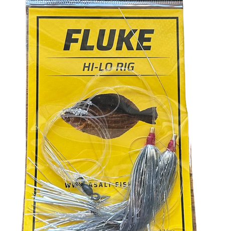 A packaged Fluke Hi-Lo Rig fishing lure with silver flash and spinner blade, displayed against a yellow background with the brand Asalt visible.